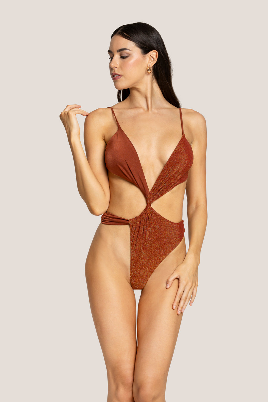 Rust-coloured one-shoulder swimsuit on neutral background